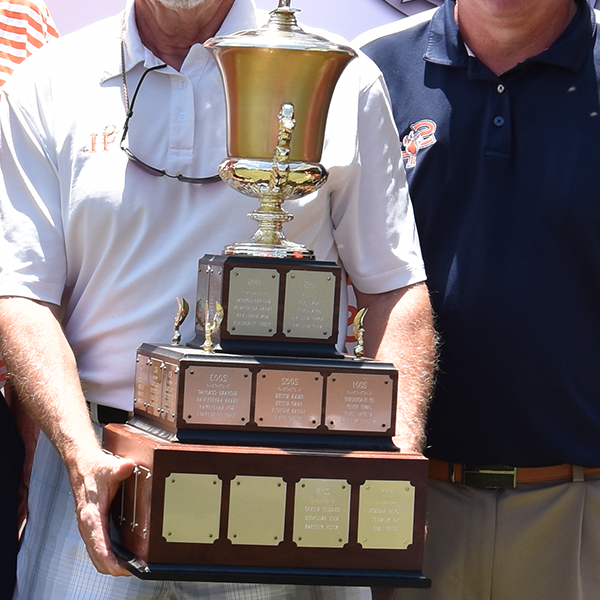 Person with SHSU polo holding a large trophy.