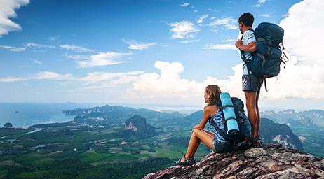 man and woman on mountain looking out to land